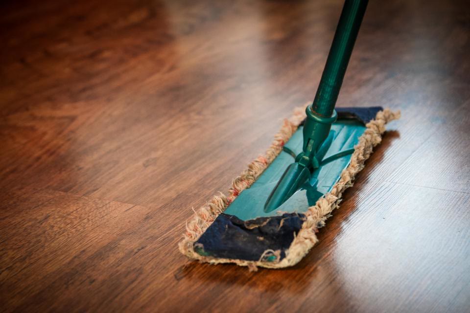 Timber floor mopped during a bond clean