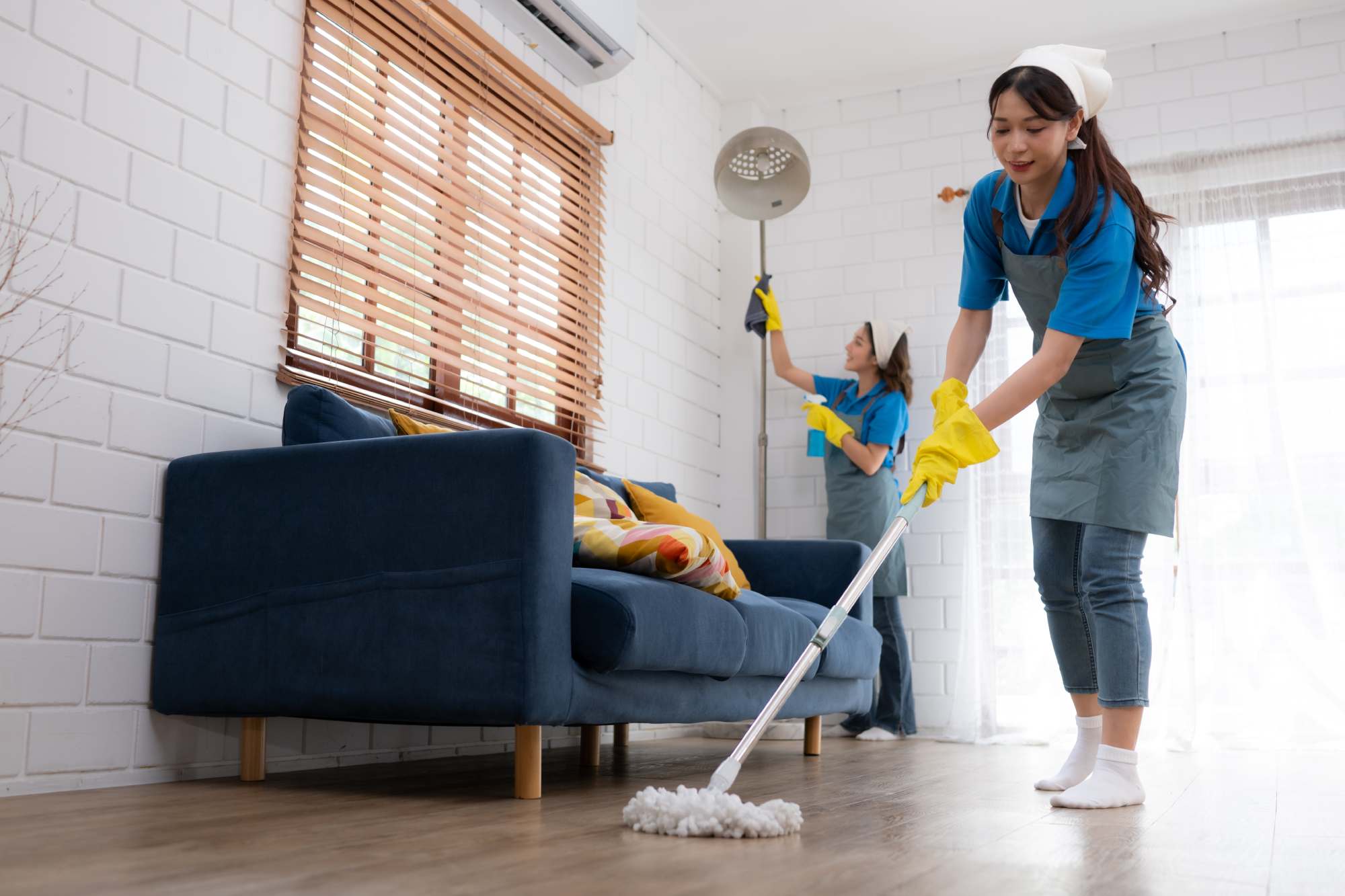 Cleaners mopping floors during a Brisbane bond clean